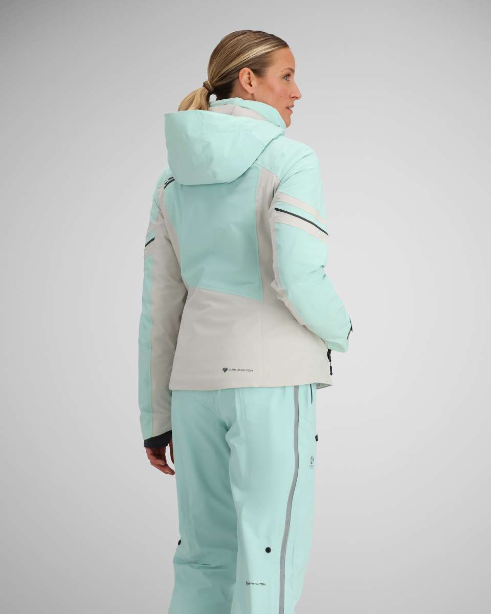 Obermeyer Women's Platinum Insulated Jacket 2024 - A light blue and white jacket with a hood, featuring black zippers on the chest and sleeves.