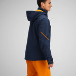Obermeyer Raze Insulated Tall Jacket 2024 - A navy blue jacket with a yellow zipper and black accents on the hood.