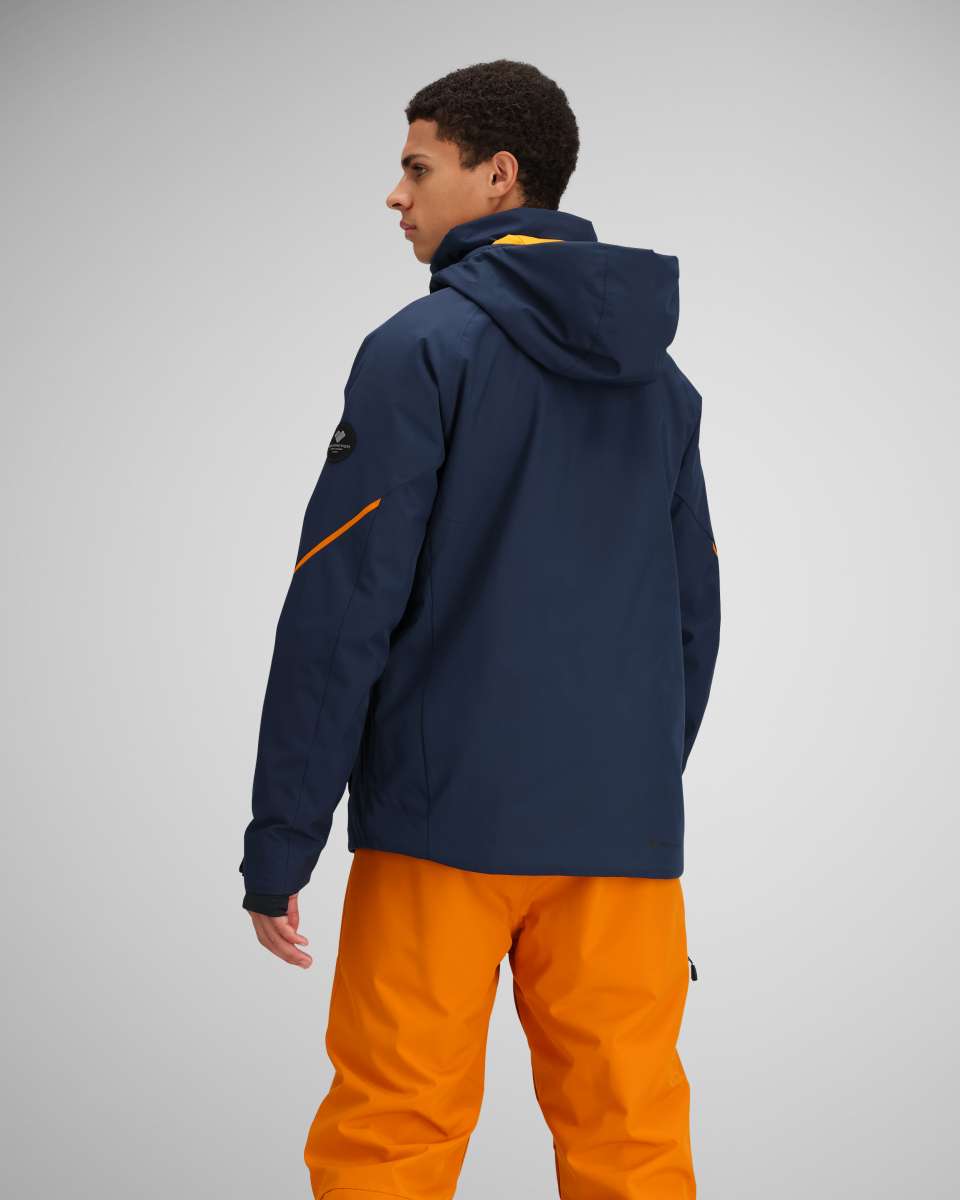 Obermeyer Raze Insulated Tall Jacket 2024 - A navy blue jacket with a yellow zipper and black logo on the left sleeve.