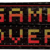 Oneball Game Over Stomp Pad 2024 - A black stomp pad with a pixelated "GAME OVER" design in yellow and red letters.
