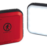 Outdoor Tech Fuel Lantern Power Bank - A red square power bank with a circular logo featuring a person skiing in the center, and three small black dots above it.