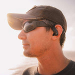 Outdoor Tech Mantas 2.0 Wireless Earbuds - Black earbuds with silver accents and a black charging case.