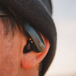 Outdoor Tech Mantas 2.0 Wireless Earbuds - A pair of black wireless earbuds with a white logo on the right bud.