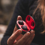 Outdoor Tech Pearls Wireless Earbuds - A pair of black wireless earbuds with a red logo on each.