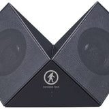 Outdoor Tech Twin Peaks Portable Speaker - Gray speaker with a circular logo featuring an outline of a person hiking, and two speakers on either side.