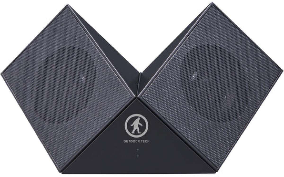Outdoor Tech Twin Peaks Portable Speaker - Gray speaker with a circular logo featuring an outline of a person hiking, and two speakers on either side.