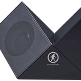 Outdoor Tech Twin Peaks Portable Speaker - A black portable speaker with a mesh front and a circular logo featuring a mountain peak design.