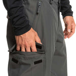 Quiksilver Porter Insulated Pant 2024 - A pair of dark gray insulated pants with a zippered pocket on the side and a black logo patch near the bottom hem.