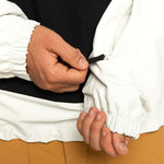 Quiksilver Steeze Shell Jacket 2024 - A white jacket with a black zipper and black drawstring at the waist.