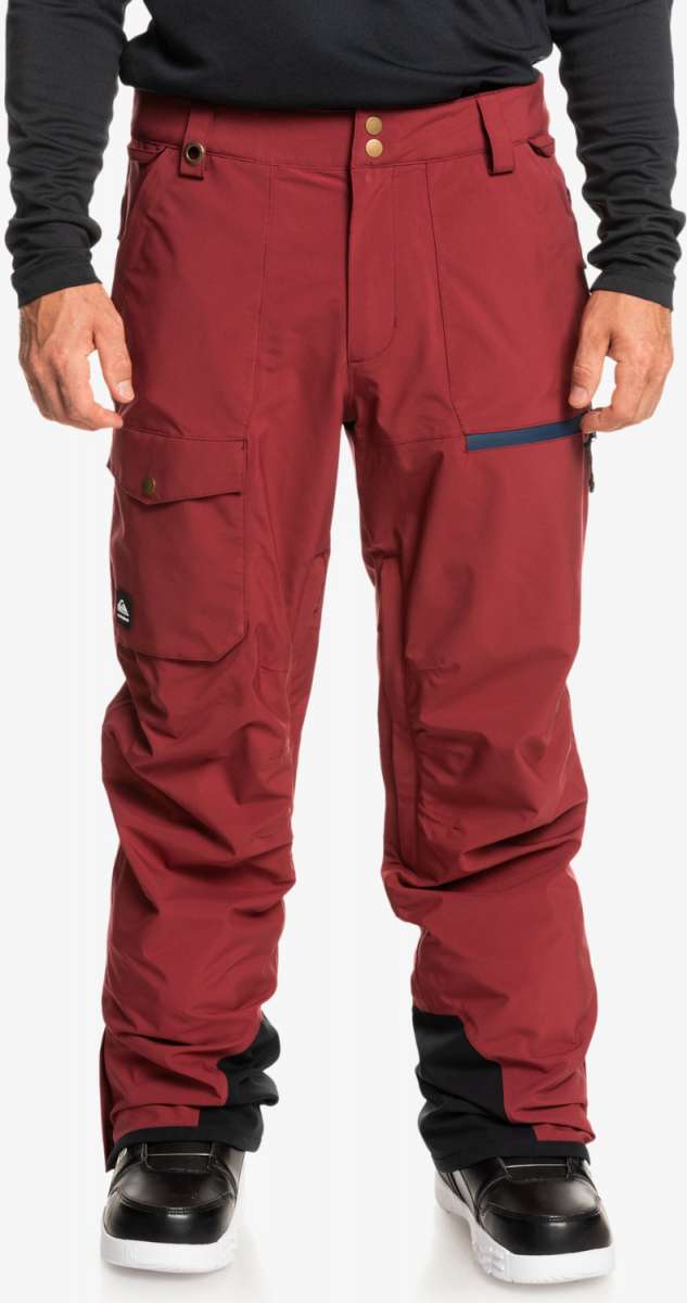 Quiksilver Utility Shell Pant 2023 - A pair of red snow pants with a black logo on the left leg pocket.