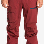 Quiksilver Utility Shell Pant 2023 - A pair of red snow pants with a black logo on the left leg pocket.