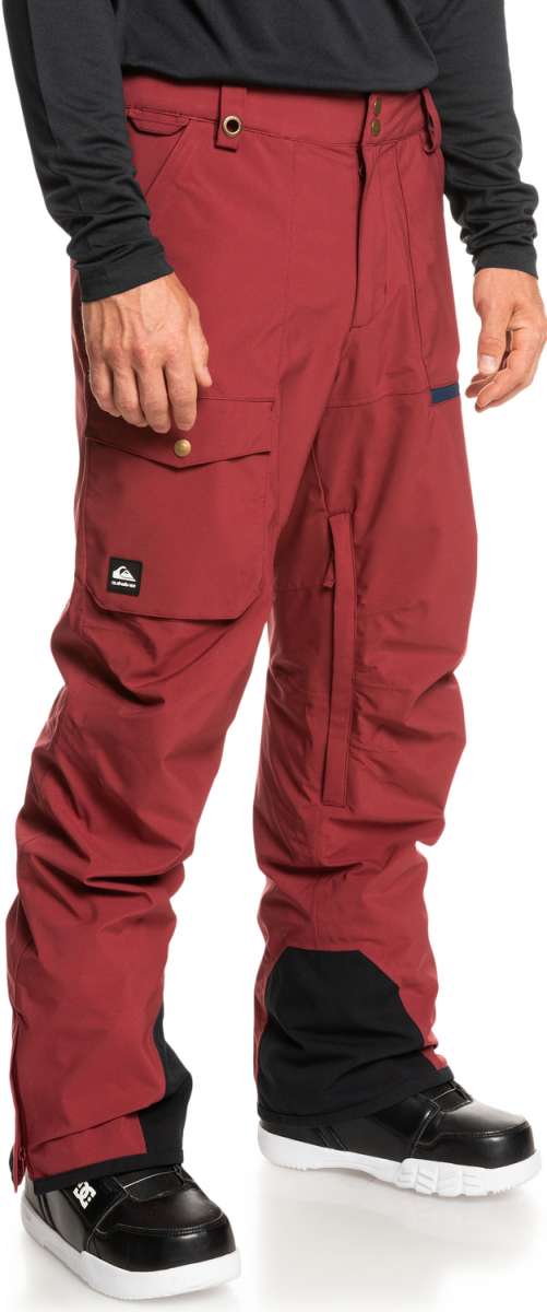 Quiksilver Utility Shell Pant 2023 - A pair of red snow pants with a black logo on the left leg pocket.