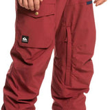 Quiksilver Utility Shell Pant 2023 - A pair of red snow pants with a black logo on the left leg pocket.