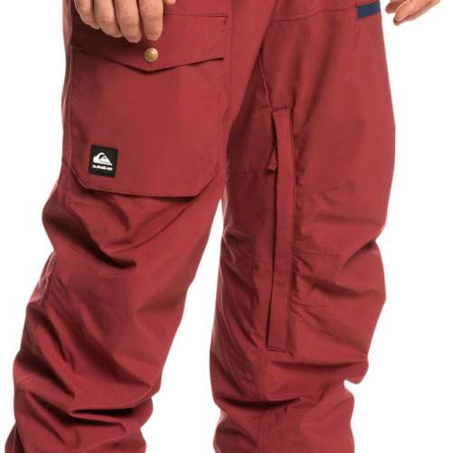 Quiksilver Utility Shell Pant 2023 - A pair of red snow pants with a black logo on the left leg pocket.