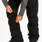 Quiksilver Utility Shell Pant 2023 - Black pants with a zippered pocket on the thigh and adjustable Velcro straps at the ankles.