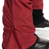Quiksilver Utility Shell Pant 2023 - A pair of red snow pants with black trim and a zippered pocket on the side.