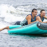 Radar Edge 2 Inflatable Towable Tube 2022 - Blue tube with black stripes and white logo on front, being pulled by a boat in choppy water.