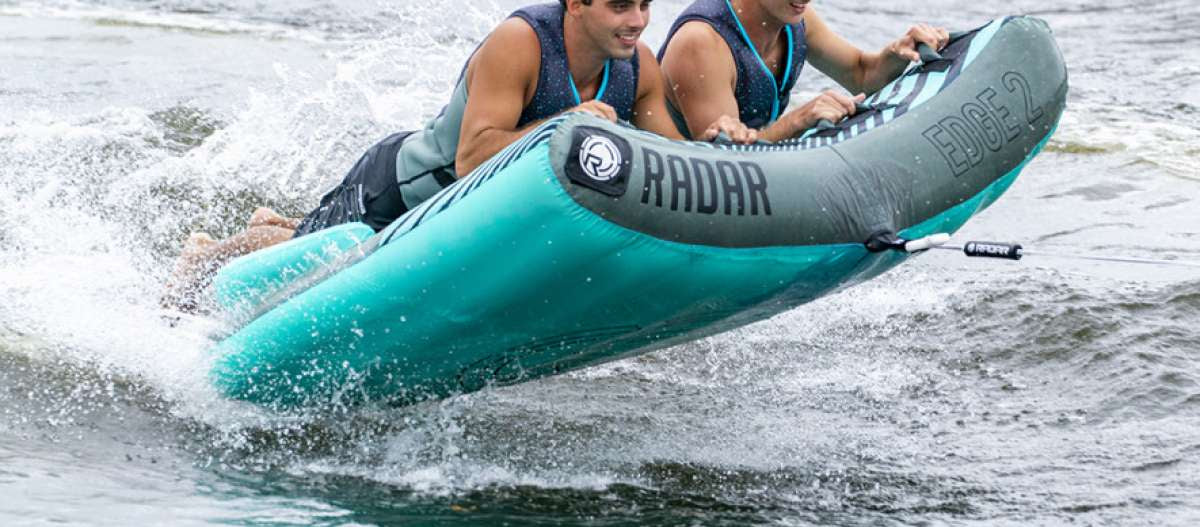 Radar Edge 2 Inflatable Towable Tube 2022 - A blue and gray inflatable tube with a black logo on the front, floating in water.