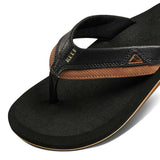 Reef Cushion Dawn Sandal 2022 - A pair of brown sandals with a strap that has a small triangle logo on it.
