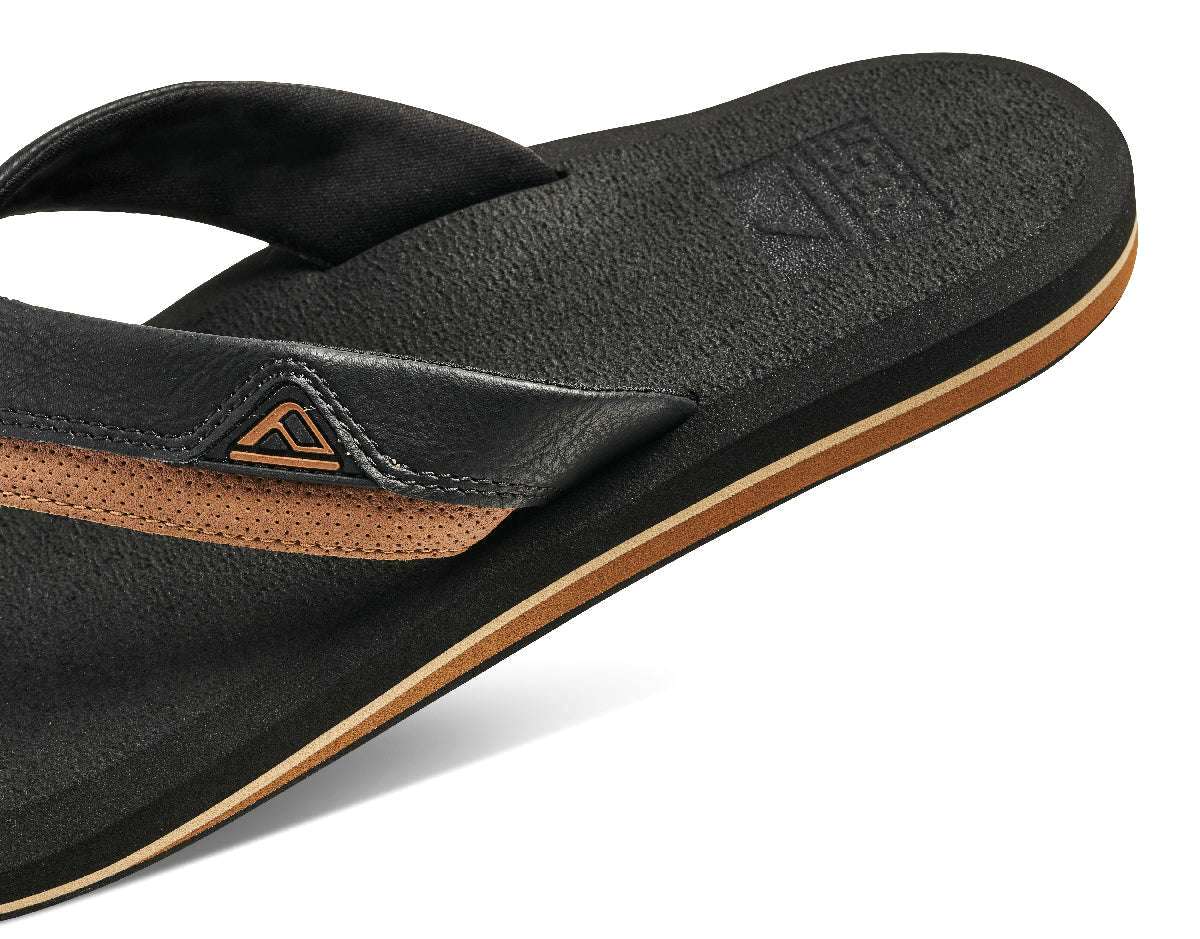 Reef Cushion Dawn Sandal 2022 - A pair of black sandals with a tan sole and strap.