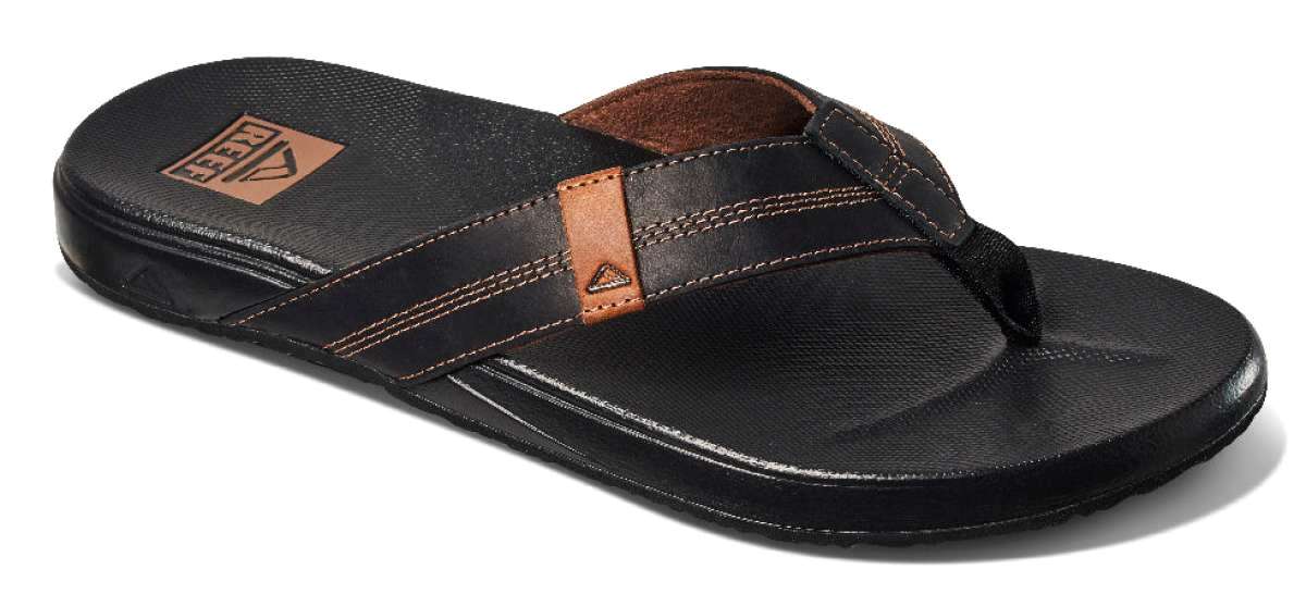 Reef Cushion Phantom LE Sandal 2022 - A black sandal with a brown logo on the strap and a textured footbed.