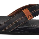 Reef Cushion Phantom LE Sandal 2022 - A black sandal with a brown strap and logo on top of foot.