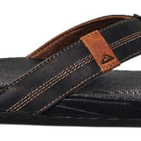 Reef Cushion Phantom LE Sandal 2022 - A black sandal with a brown strap and logo on top of foot.