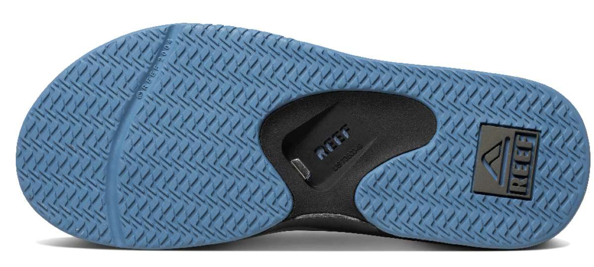 Reef Men's Fanning Sandal - A light blue sandal with a textured sole and a logo on the strap.