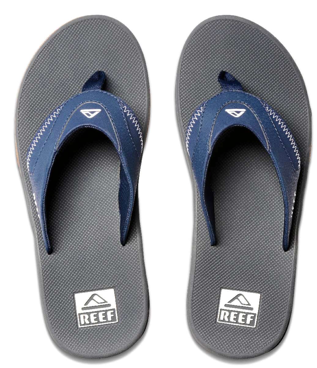 Reef Men's Fanning Sandal - A pair of navy blue sandals with white stitching on the straps, featuring a logo at the top strap and a textured footbed.
