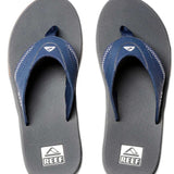 Reef Men's Fanning Sandal - A pair of navy blue sandals with white stitching on the straps, featuring a logo at the top strap and a textured footbed.