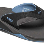 Reef Men's Fanning Sandal - A pair of black sandals with a blue sole and strap.