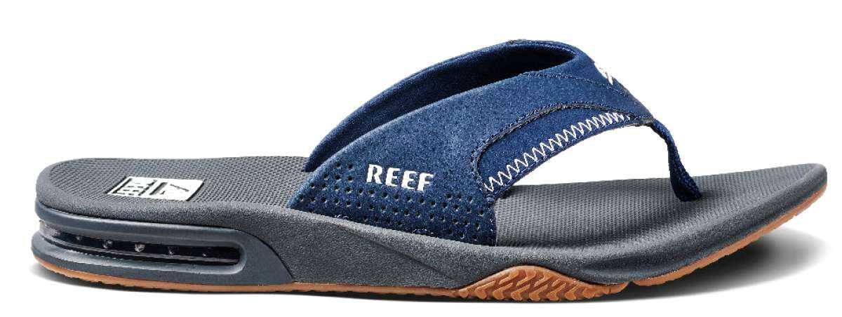 Reef Men's Fanning Sandal - A pair of blue sandals with a strap that goes between the big and second toe, featuring a white logo on the strap.