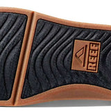 Reef Ortho-Seas Sandal - A pair of brown sandals with a thick sole and straps, featuring a textured pattern on the strap.