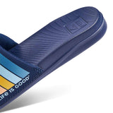 Reef X Life Is Good Women's Slide 2022 - A pair of navy-blue slides with a logo on the strap and a textured sole.