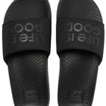 Reef X Life Is Good Women's Slide 2022 - A pair of black slide sandals with a textured footbed and embossed logo on the strap.