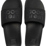 Reef X Life Is Good Women's Slide 2022 - A pair of black slide sandals with a textured footbed and embossed logo on the strap.