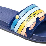 Reef X Life Is Good Women's Slide 2022 - A pair of blue slide sandals with a logo on the strap.