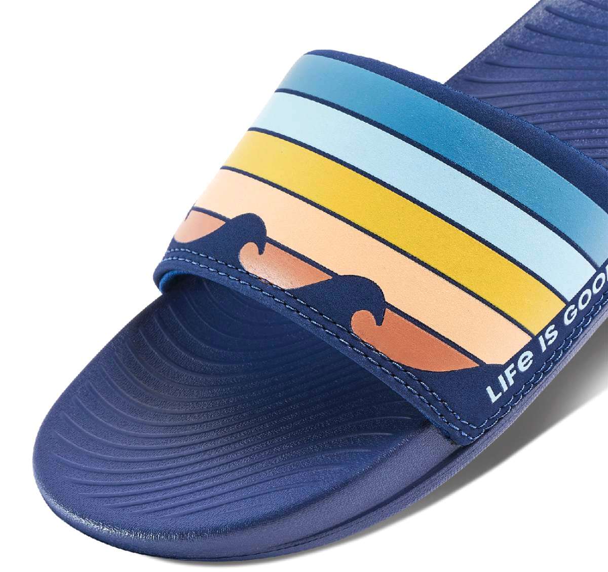 Reef X Life Is Good Women's Slide 2022 - A pair of blue slide sandals with a wave design on the strap.
