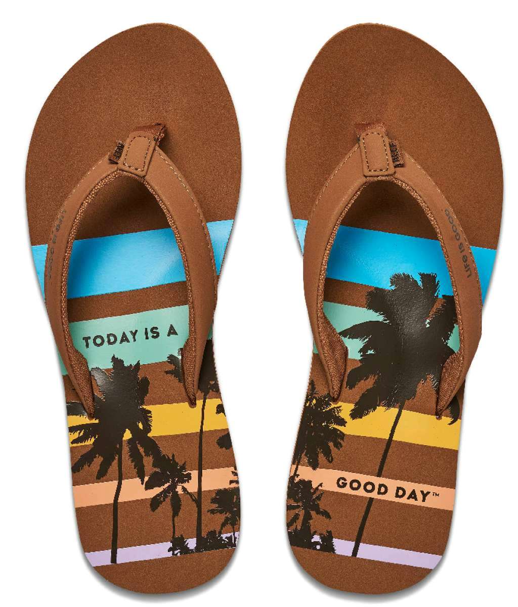 Reef Women's X Life Is Good Sandal - A pair of brown sandals with a palm tree and sunset design on the straps.