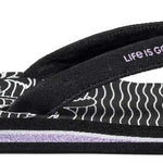 Reef Women's X Life Is Good Sandal - A black sandal with a white logo on top of the footbed and a palm tree design on the strap.