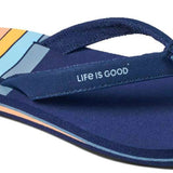 Reef Women's X Life Is Good Sandal - A pair of navy blue sandals with a light orange logo on the strap.