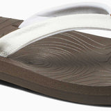Reef Women's Zen Love Sandal 2020 - A pair of white sandals with a brown strap and sole, featuring a circular pattern on the strap.