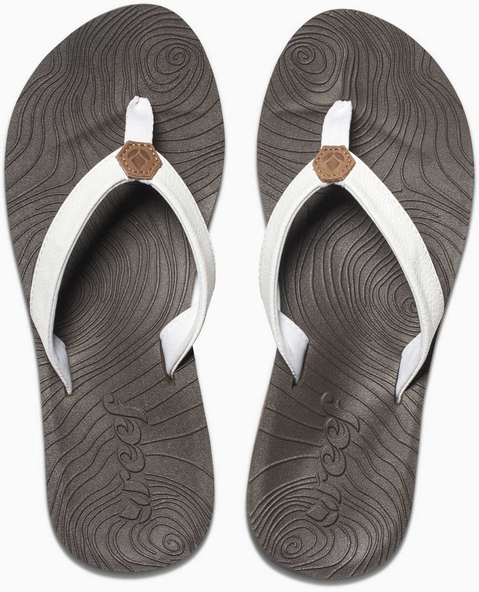 Reef Women's Zen Love Sandal 2020 - A pair of women's sandals with a tan strap and a brown logo on top, featuring a wave pattern on the sole.