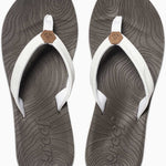 Reef Women's Zen Love Sandal 2020 - A pair of women's sandals with a tan strap and a brown logo on top, featuring a wave pattern on the sole.