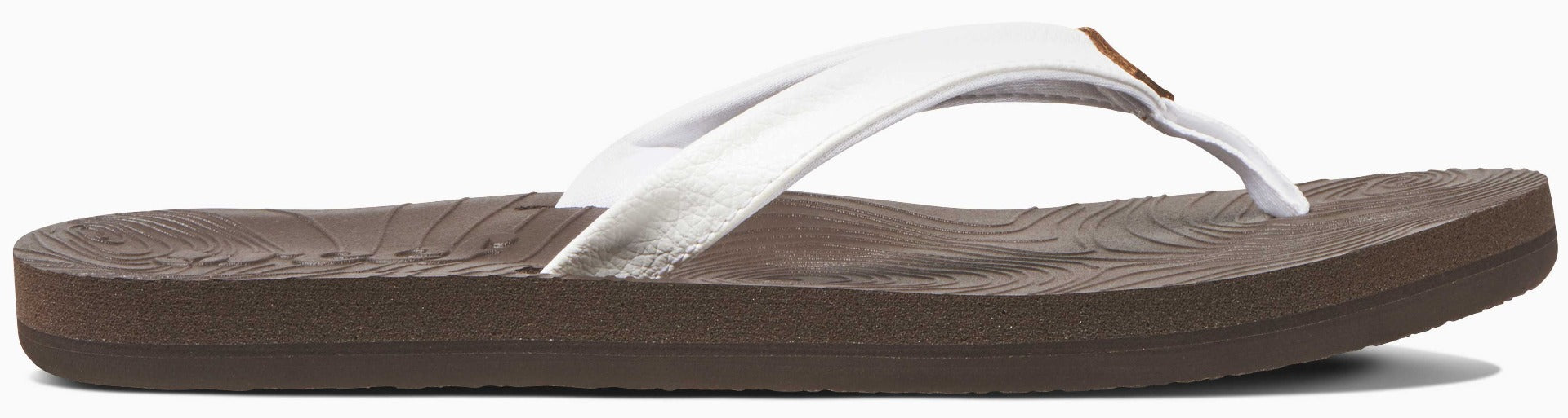 Reef Women's Zen Love Sandal 2020 - A brown sandal with a tan strap and a small, circular logo on the toe strap.