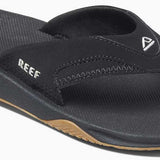 Reef Men's Fanning Sandal 2020 - A pair of black sandals with a white logo on the strap.