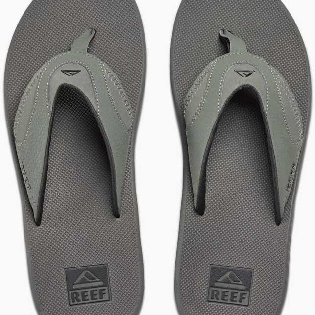 Reef Men's Fanning Sandal - A pair of gray sandals with a strap and toe post, featuring a small logo on the top strap.