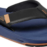 Reef Men's Fanning Low Sandal - A blue sandal with a brown logo on the strap and a clear sole.