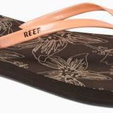 Reef Women's Bliss-Full Sandal 2020 - A pair of brown sandals with a strap and toe post, featuring a floral pattern on the footbed.