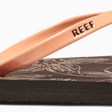 Reef Women's Bliss-Full Sandal 2020 - A brown sandal with a strap and toe post, featuring a palm tree design on the footbed.